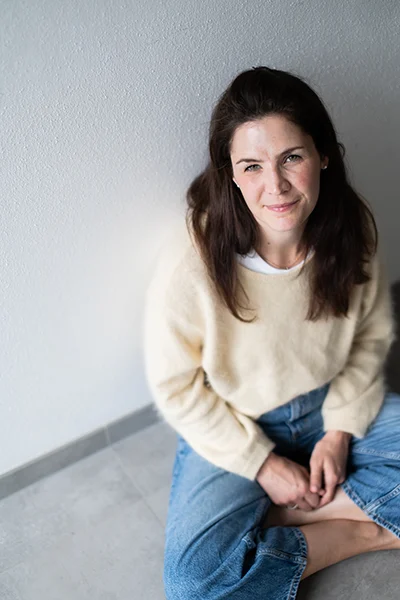 Lena-Heineman-Fotografin-Heilbronn-12 Lena Heinemann Fotografin aus Heilbronn, Bild einer lächelnden Frau mit gelben Pulli, die auf dem Boden sitzt